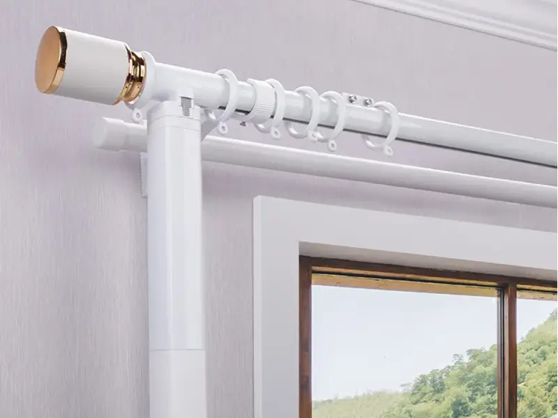 Tubular curtain motor and aluminum track installed above a window